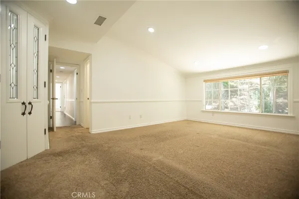 an empty room with a empty space and windows