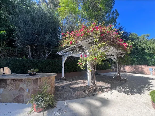a front view of a house with a tree