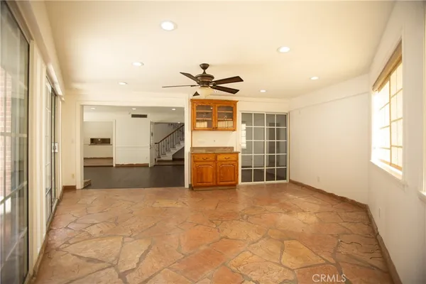 a view of a livingroom with a ceiling fan and window