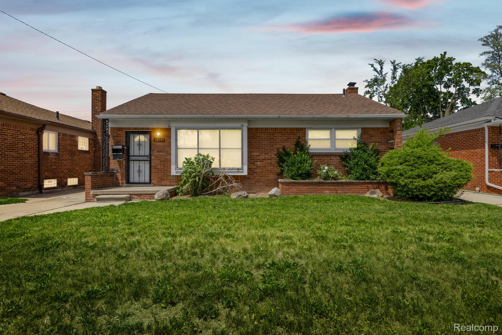20261 Burt Road Detroit, MI 48219 - Photo 2 of 23 Brick ranch-style home featuring a prominent front lawn