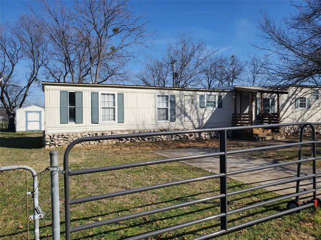 a view of a balcony with wooden floor and fence
