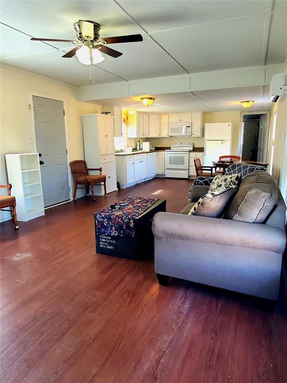 103 Hackberry Lane Roanoke, TX 76262 - Photo 4 of 9 a living room with furniture and a wooden floor