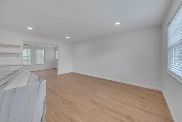 an empty room with windows and entrance