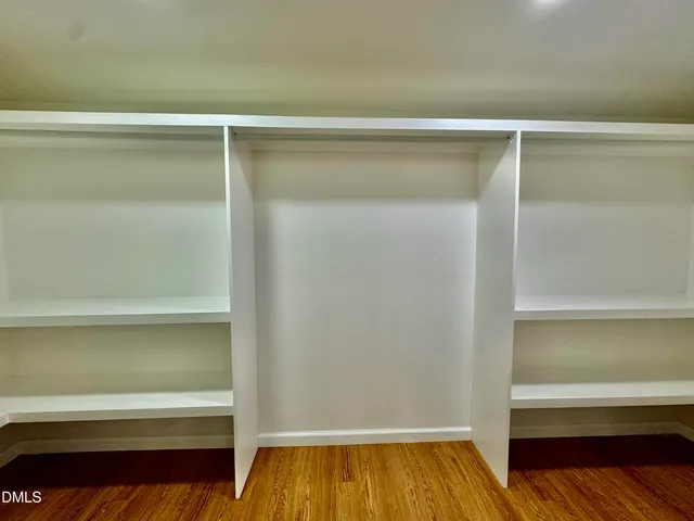 a view of a room with wooden floor