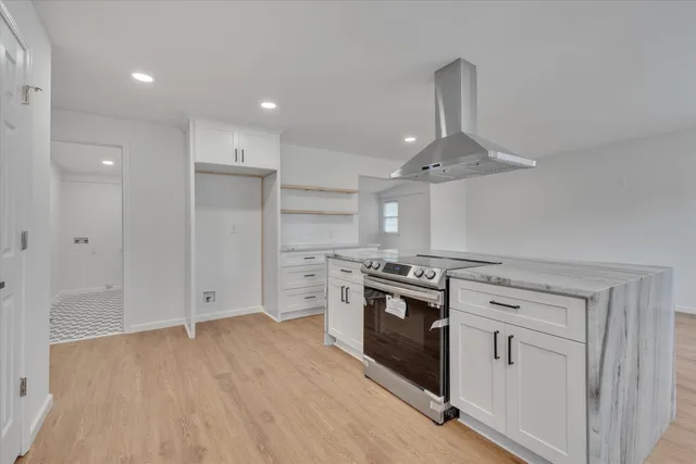 a kitchen with stainless steel appliances granite countertop a stove and a refrigerator
