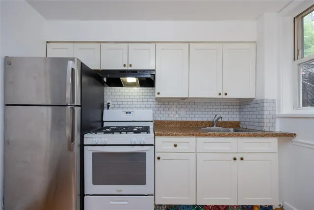 a kitchen with appliances cabinets and a sink