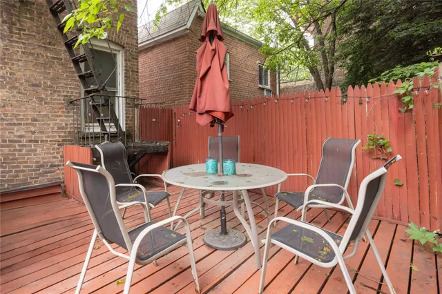 a backyard of a house with table and chairs