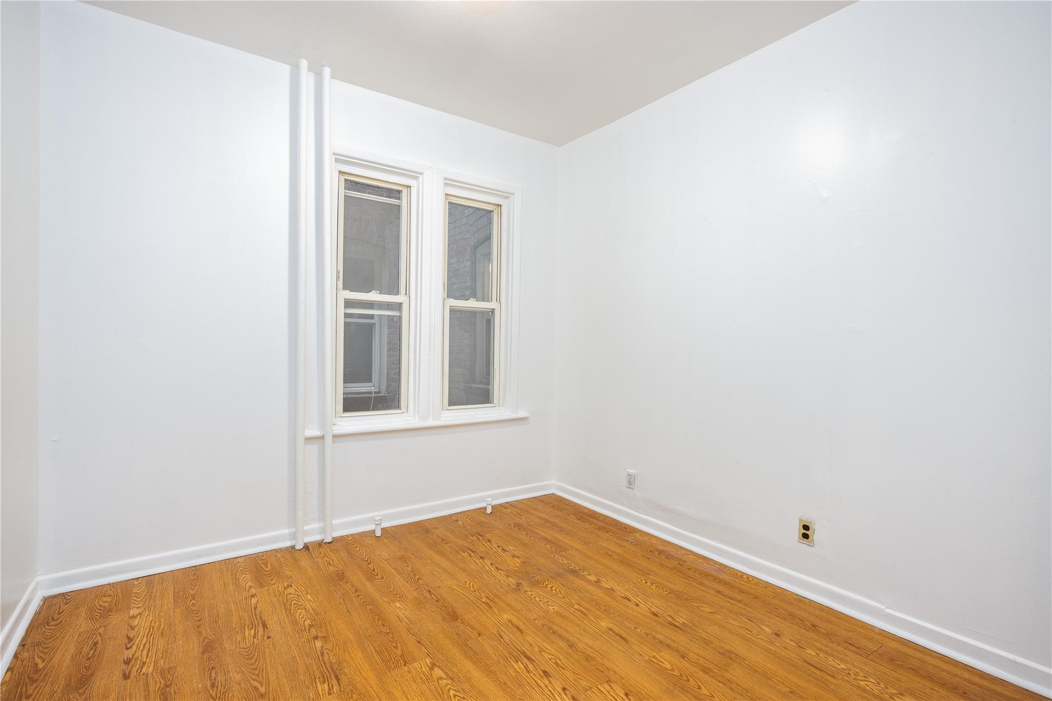 3496 Fort Independence Street Bronx, NY 10463 - Photo 10 of 22 a view of empty room with wooden floor