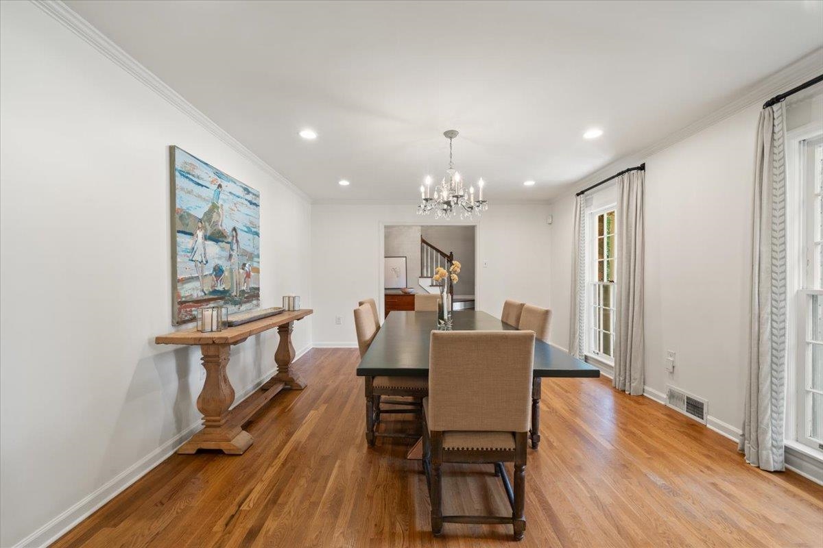 5376 Mason Road Memphis, TN 38120 - Photo 11 of 37 Dining room with crown molding, a chandelier, wood finished floors, and recessed lighting