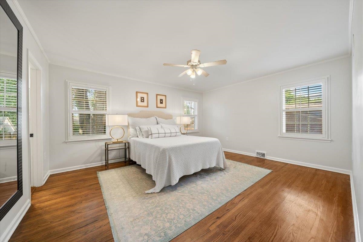 5376 Mason Road Memphis, TN 38120 - Photo 23 of 37 Bedroom featuring ornamental molding, dark wood-style flooring, multiple windows, and ceiling fan