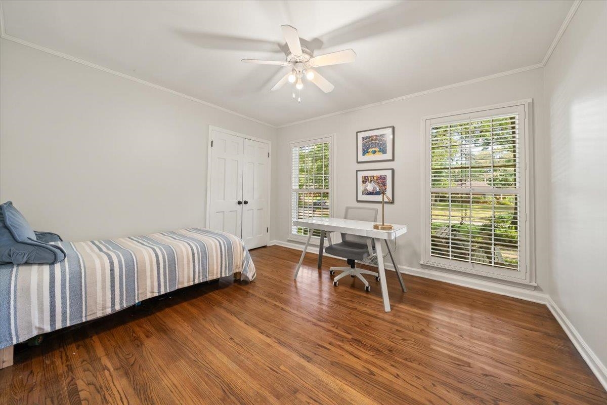 5376 Mason Road Memphis, TN 38120 - Photo 25 of 37 Bedroom featuring wood finished floors, crown molding, a closet, a desk, and ceiling fan