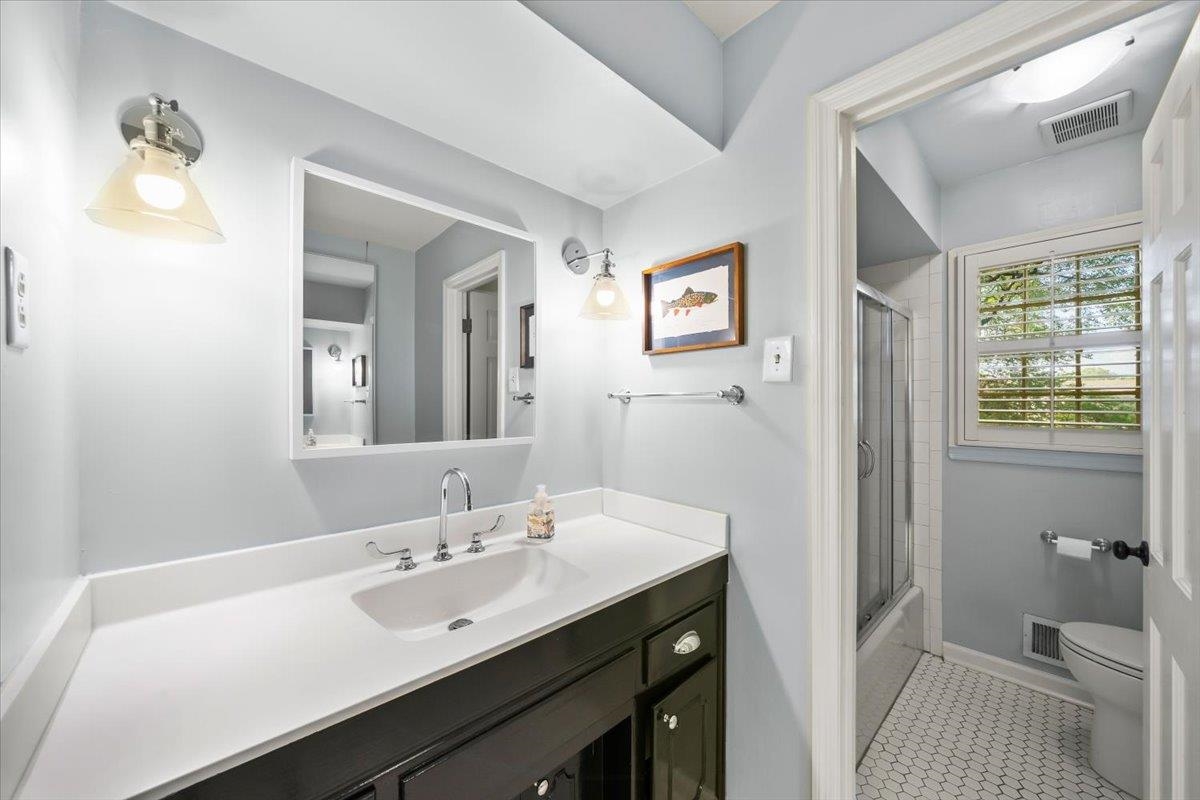 5376 Mason Road Memphis, TN 38120 - Photo 27 of 37 Bathroom with vanity, bath / shower combo with glass door, and tile patterned flooring