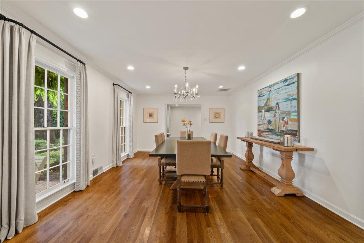5376 Mason Road Memphis, TN 38120 - Photo 5 of 37 Dining space featuring a chandelier, wood finished floors, crown molding, and recessed lighting