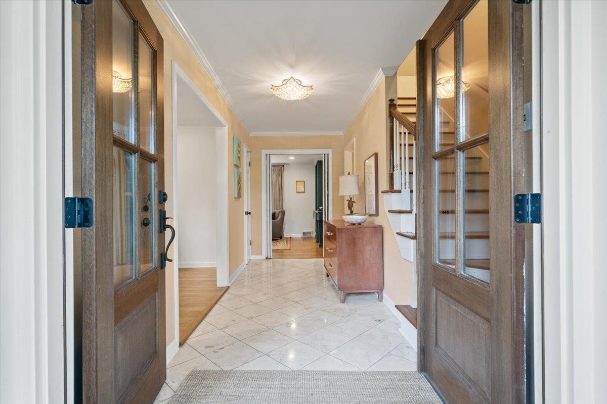 5376 Mason Road Memphis, TN 38120 - Photo 8 of 37 Foyer entrance with ornamental molding, light tile patterned flooring, and stairs