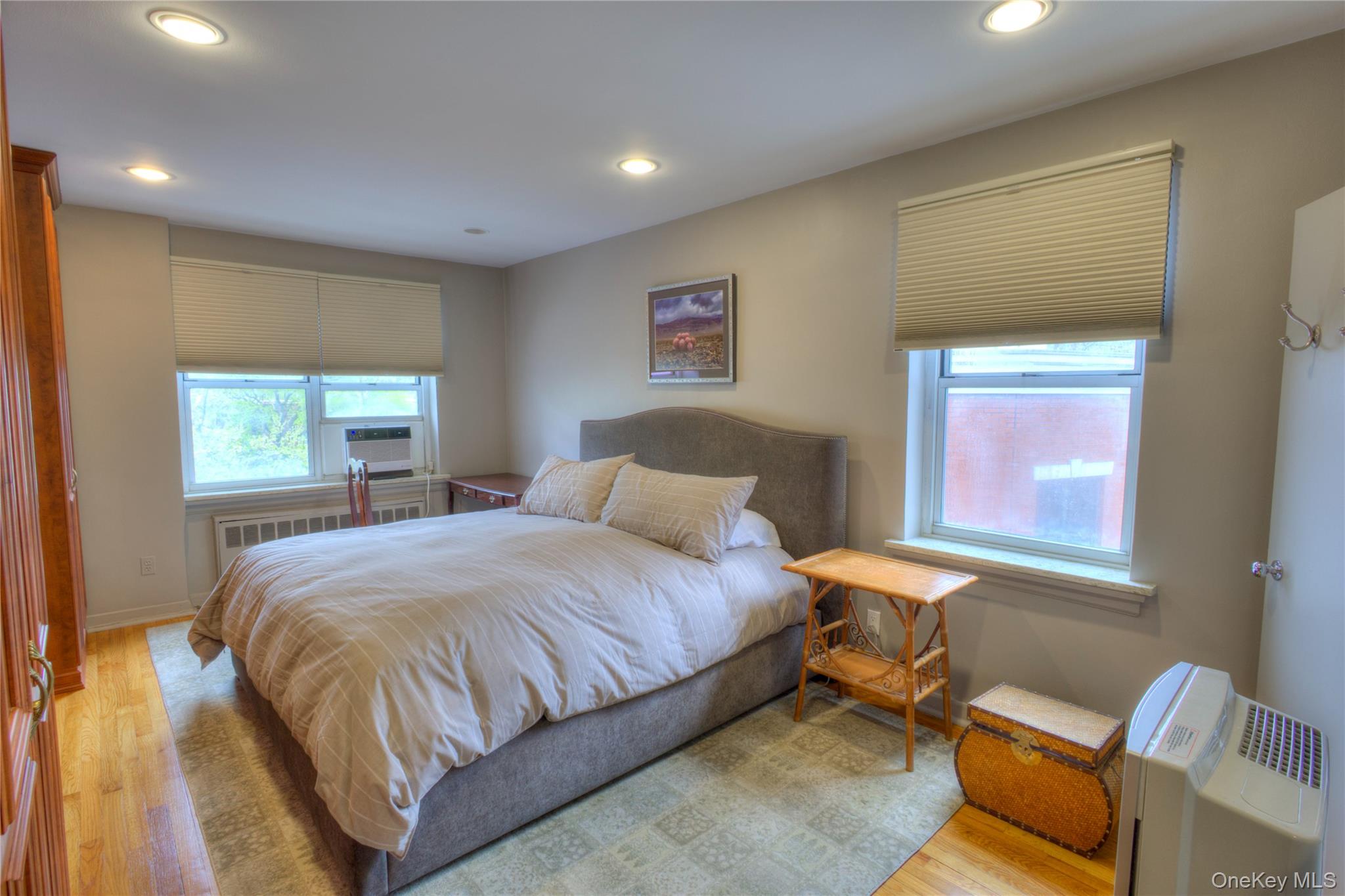 75 South Middle Neck Road, Unit 4G Great Neck, NY 11021 - Photo 16 of 37 a bedroom with a bed and wooden floor