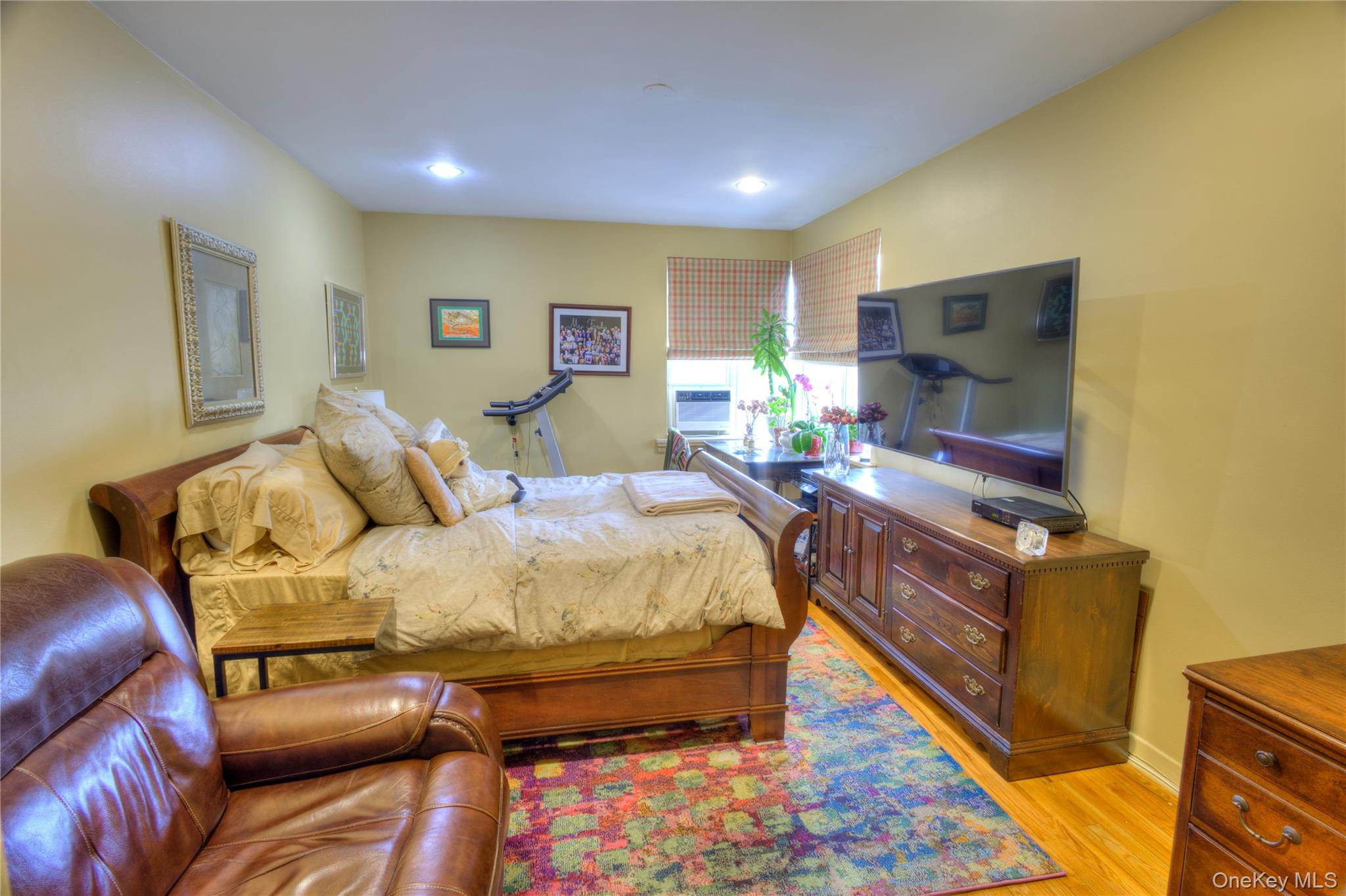 75 South Middle Neck Road, Unit 4G Great Neck, NY 11021 - Photo 18 of 37 a bed room with a bed and a television
