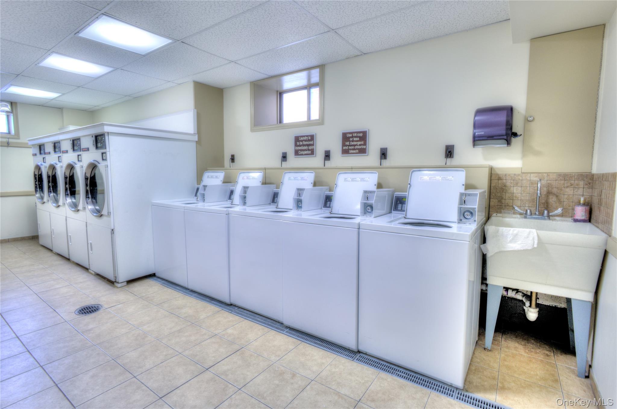 75 South Middle Neck Road, Unit 4G Great Neck, NY 11021 - Photo 22 of 37 a utility room with cabinets