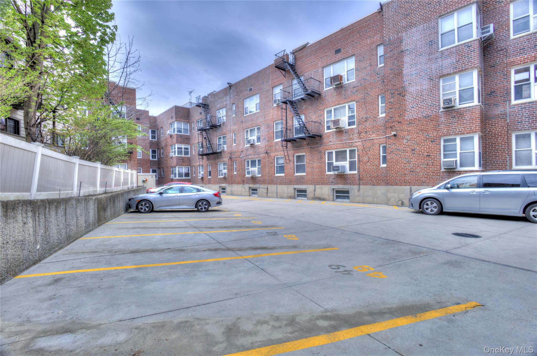 75 South Middle Neck Road, Unit 4G Great Neck, NY 11021 - Photo 27 of 37 a building with trees in front of it