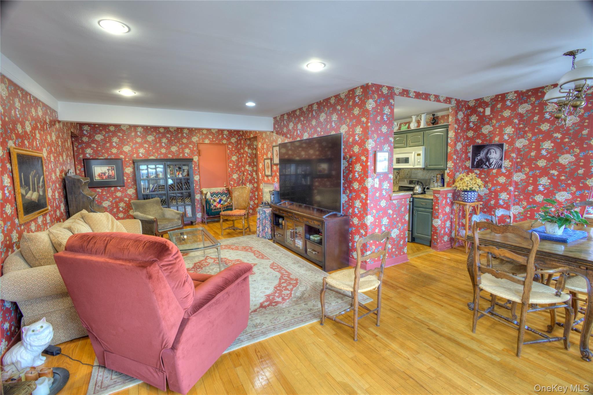 75 South Middle Neck Road, Unit 4G Great Neck, NY 11021 - Photo 6 of 37 a living room with furniture and a flat screen tv