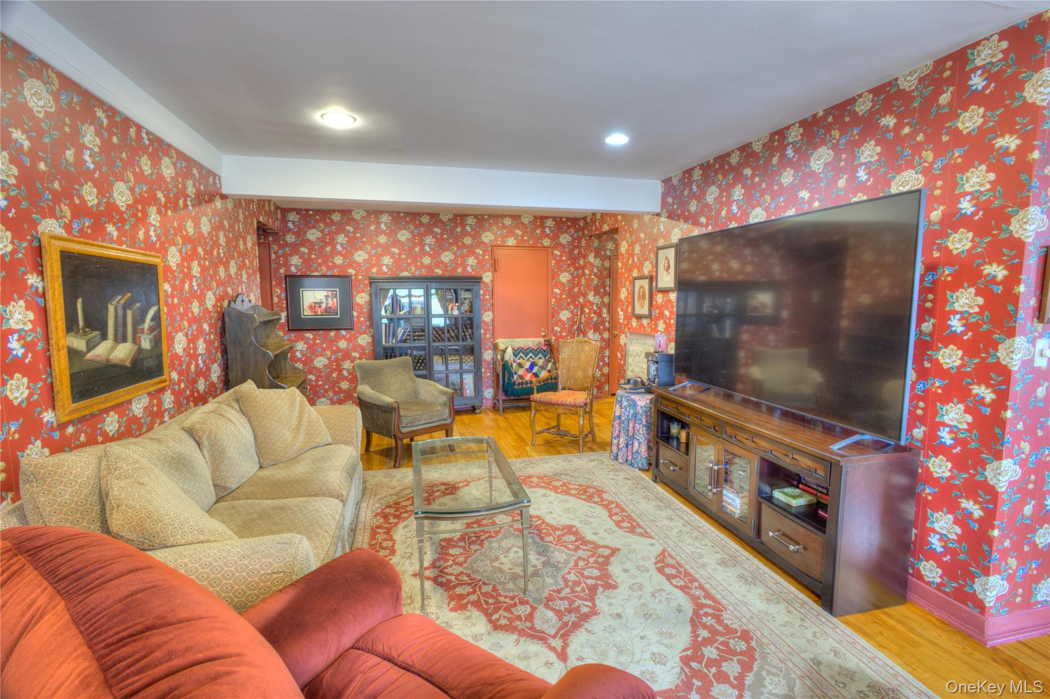 75 South Middle Neck Road, Unit 4G Great Neck, NY 11021 - Photo 7 of 37 a living room with furniture and a flat screen tv