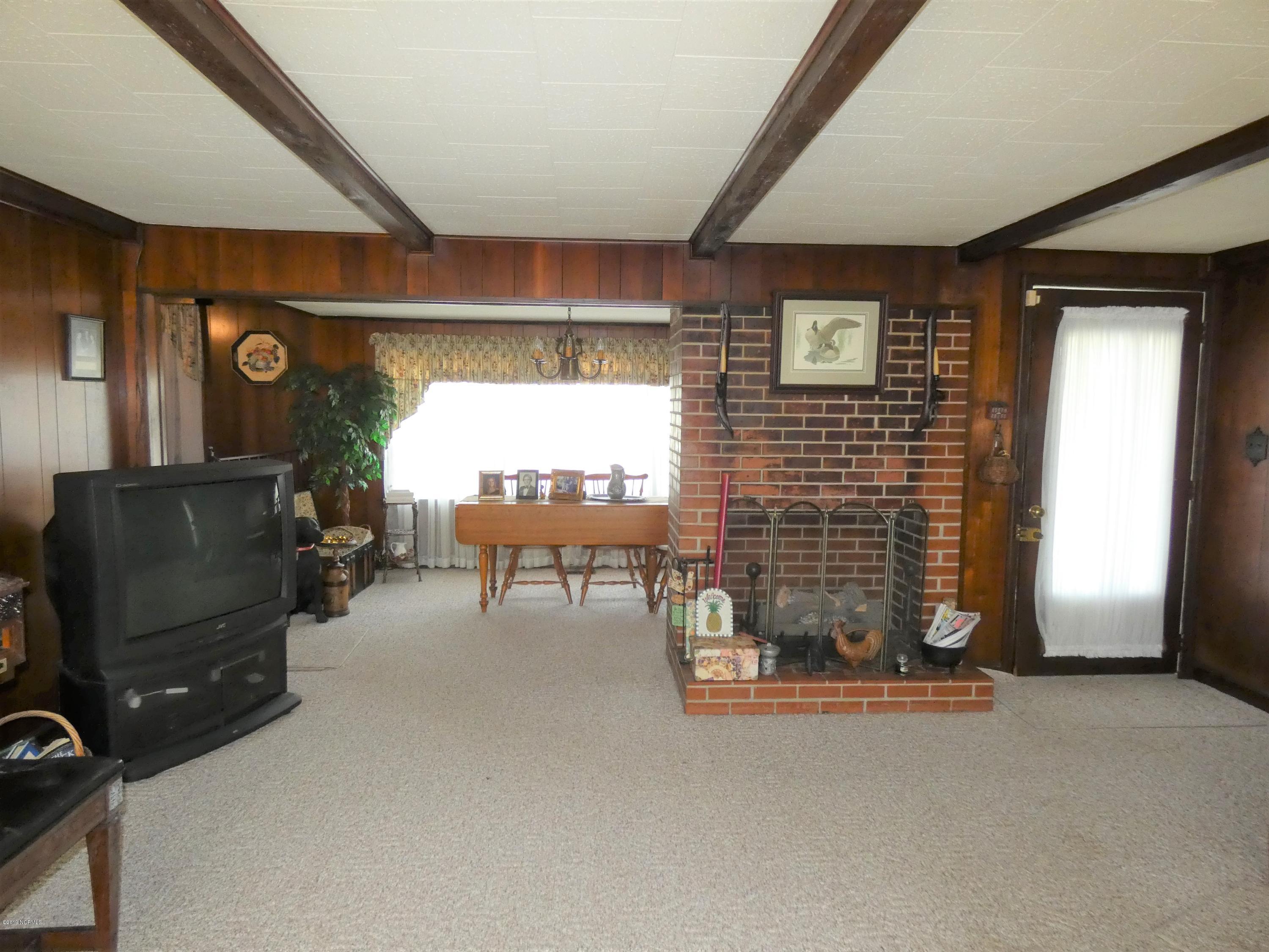 392 High House Road Clinton, NC 28328 - Photo 8 of 16 Den showing fireplace (no chimney) looking into dining room.