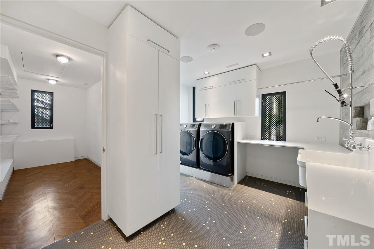 123 Hillcrest Road Raleigh, NC 27605 - Photo 20 of 30 quartz counters with waterfall treatments, scullery sink and sprayer, walk in linen closet. Penny tile and herringbone oak floors make even the laundry a pleasureable experience