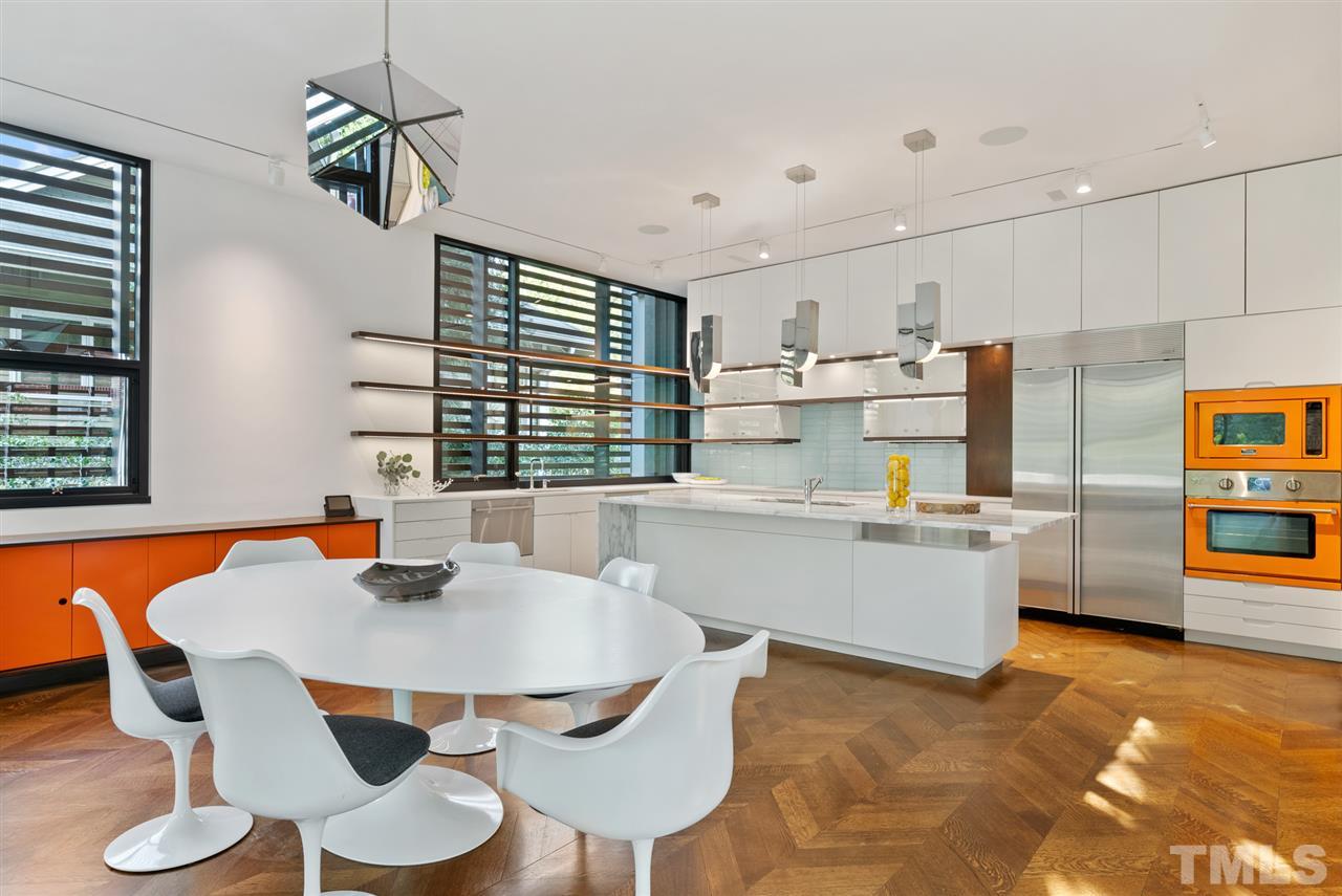 123 Hillcrest Road Raleigh, NC 27605 - Photo 3 of 30 two board-formed concrete walls define the home vertically, running from the public sidewalk to the site's private alley. These vital design components start in the basement of the four-level home and ultimately support the inverted cantilevered roof