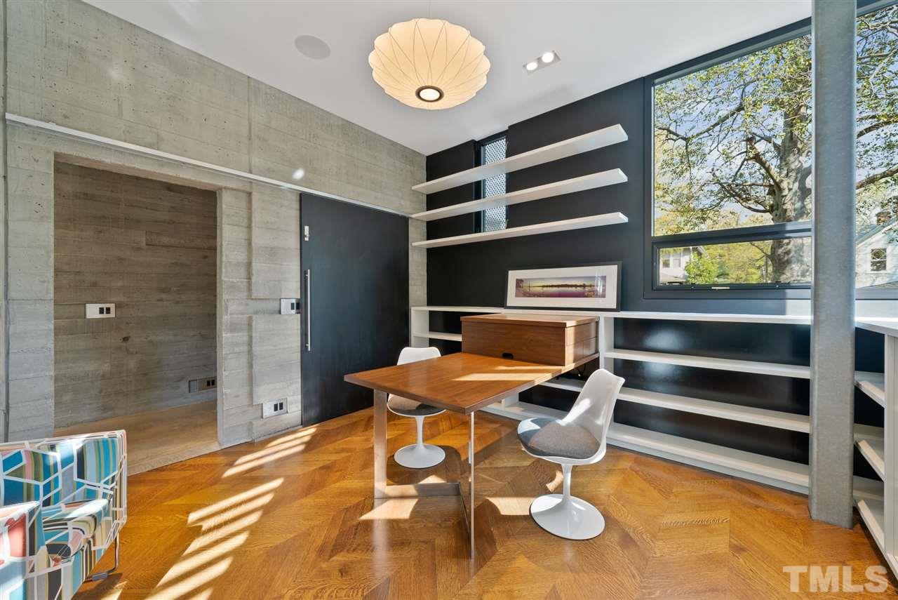 123 Hillcrest Road Raleigh, NC 27605 - Photo 10 of 30 located off the main first floor gallery, the office has built-in shelving, a partners desk, and a monitor mount