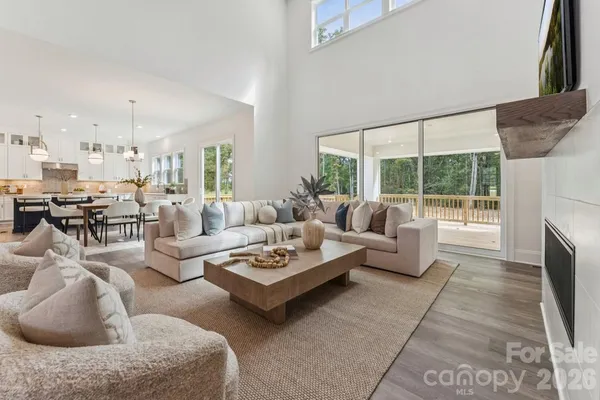 a living room with furniture a fireplace and a table