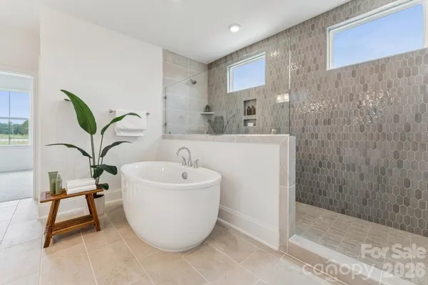 a bathroom with a bathtub sink and mirror