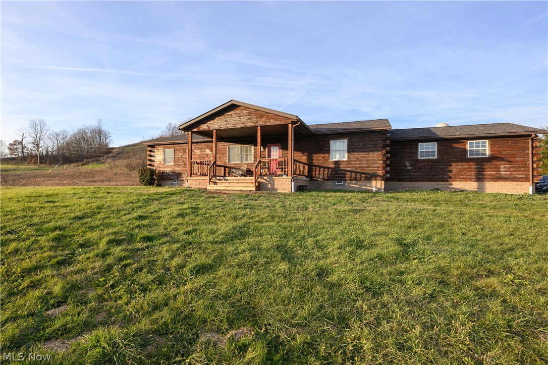 View of front of home featuring a front yard and a deck