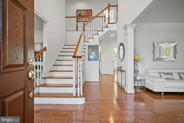 a view of entryway and hall with wooden floor