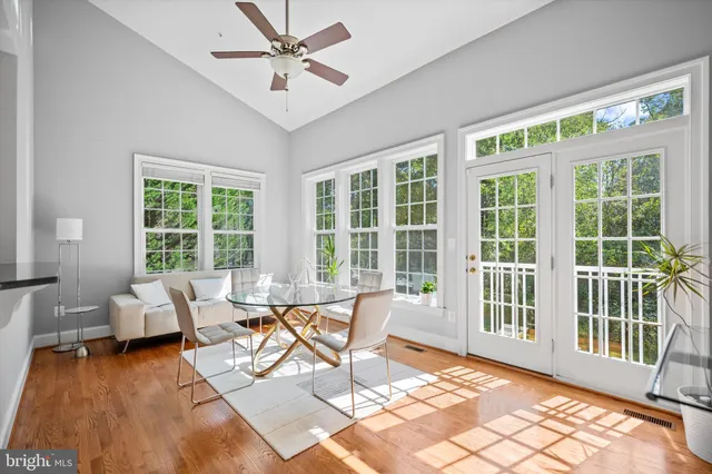 a view of a dining room with furniture wooden floor and a chandelier