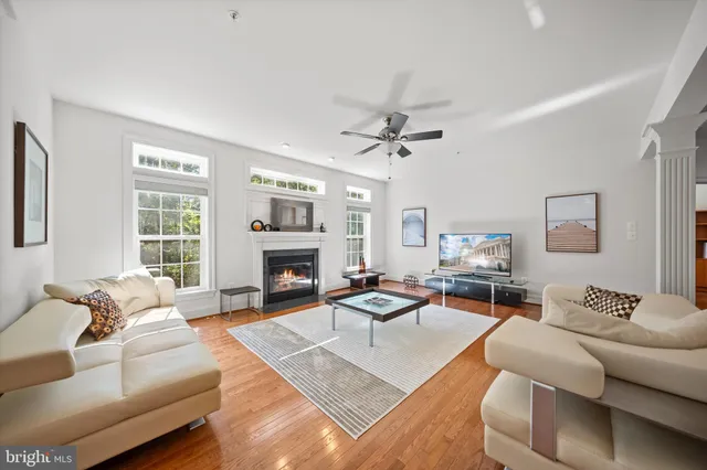 a living room with furniture fireplace and a window