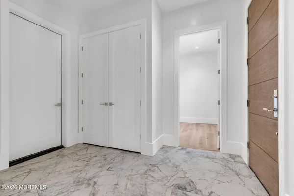a view of an entryway with wooden floor