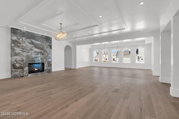 an empty room with wooden floor and fireplace