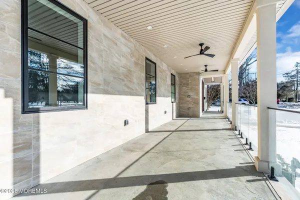 a large room with a large window and white cabinets