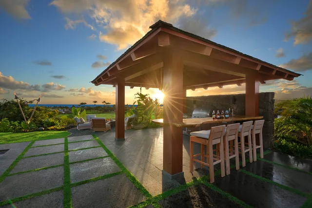a view of a patio with a table and chairs under an umbrella