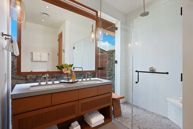 a bathroom with a sink and a mirror with toilet