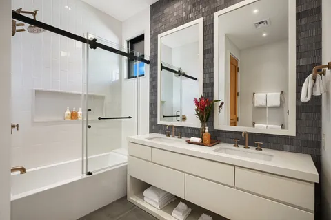 a bathroom with a double vanity sink mirror and double