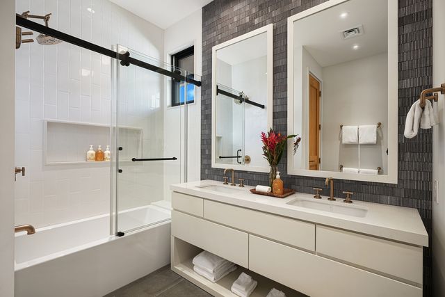 a bathroom with a double vanity sink mirror and double