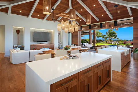a kitchen with a sink and wooden floor