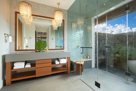 a bathroom with a sink a large mirror and a glass door shower