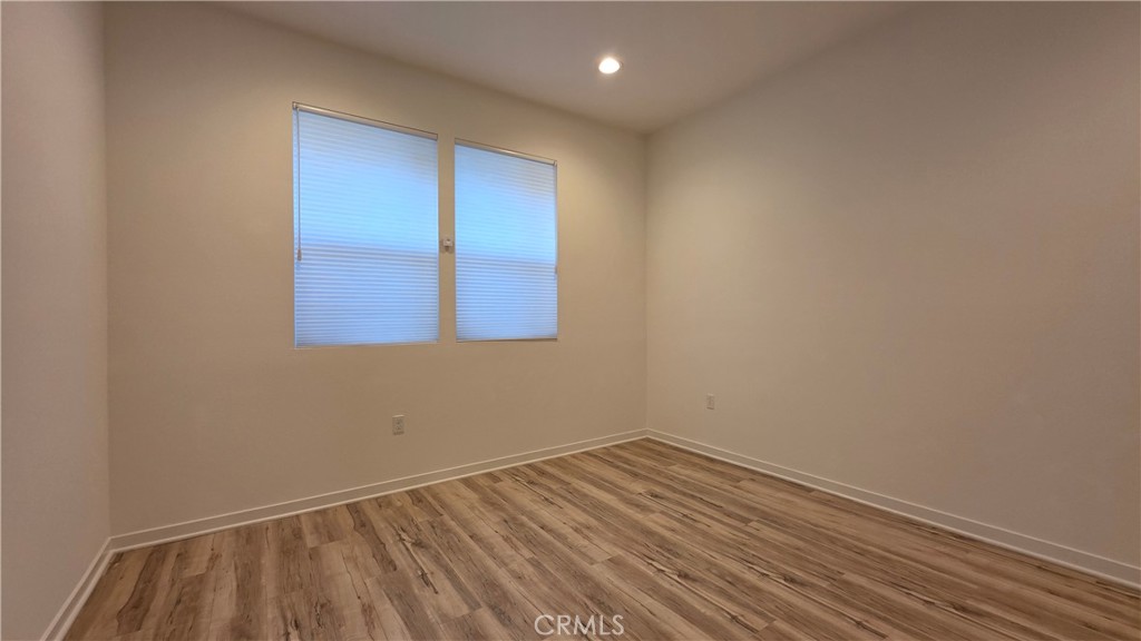 436 Village Brea Ca Brea, CA 92821 - Photo 18 of 26 an empty room with wooden floor and windows