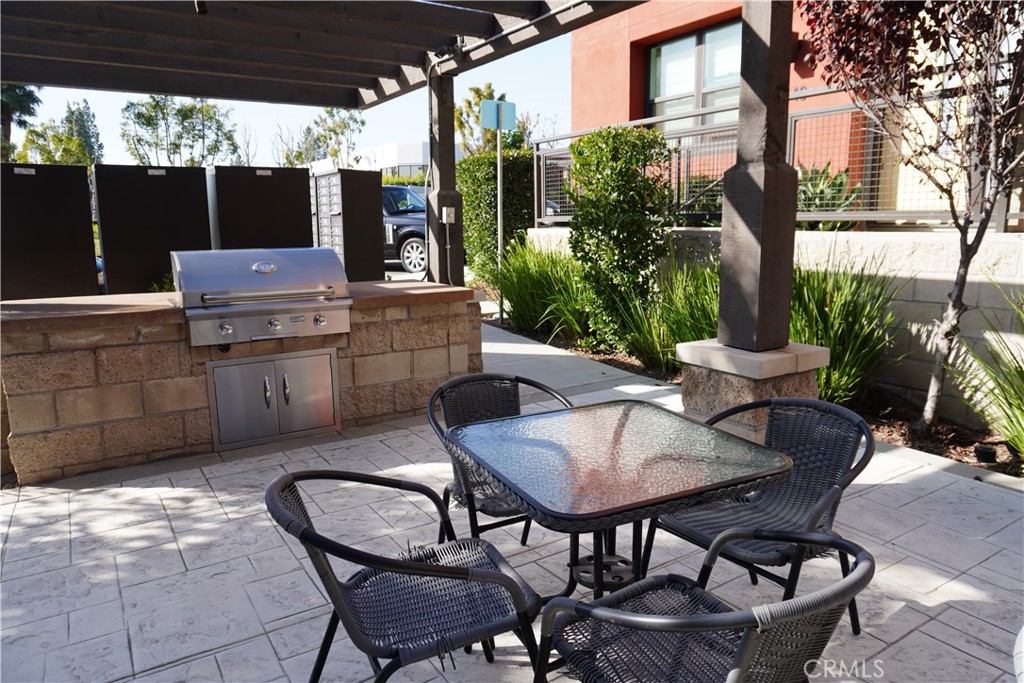 436 Village Brea Ca Brea, CA 92821 - Photo 25 of 30 a patio with table and chairs and potted plants