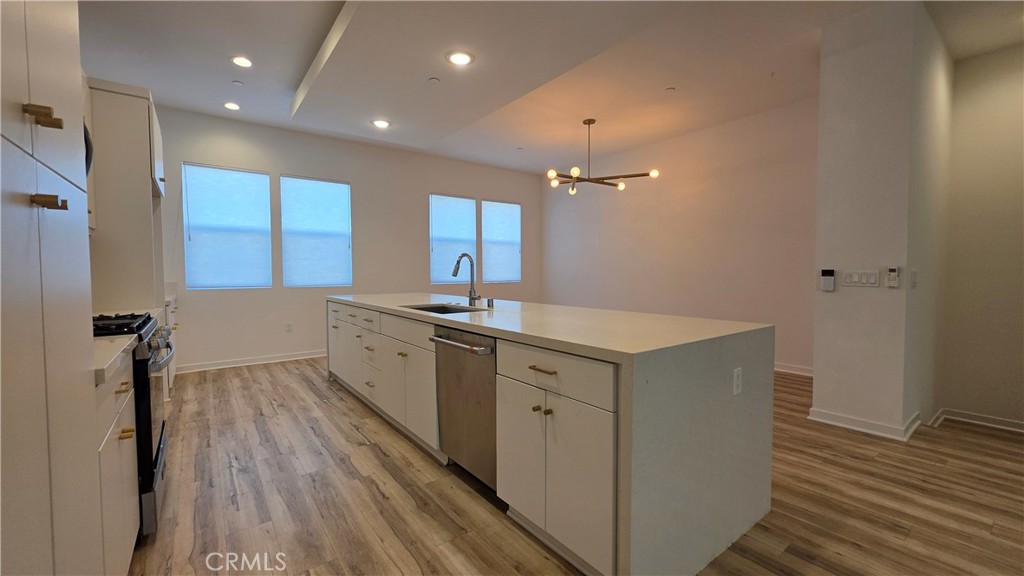 436 Village Brea Ca Brea, CA 92821 - Photo 4 of 26 a view of a kitchen with a sink and wooden floor