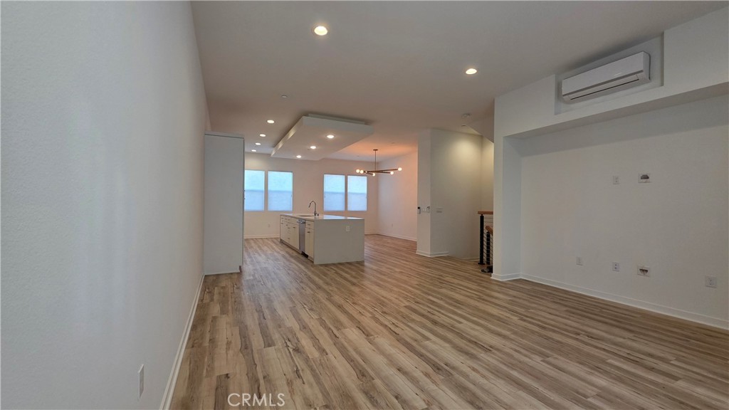 436 Village Brea Ca Brea, CA 92821 - Photo 4 of 30 a view of a room with wooden floor and windows