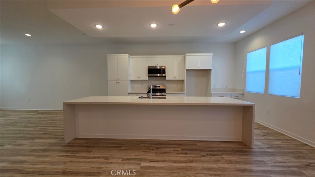 436 Village Brea Ca Brea, CA 92821 - Photo 7 of 26 a kitchen with kitchen island a stove a sink and a refrigerator
