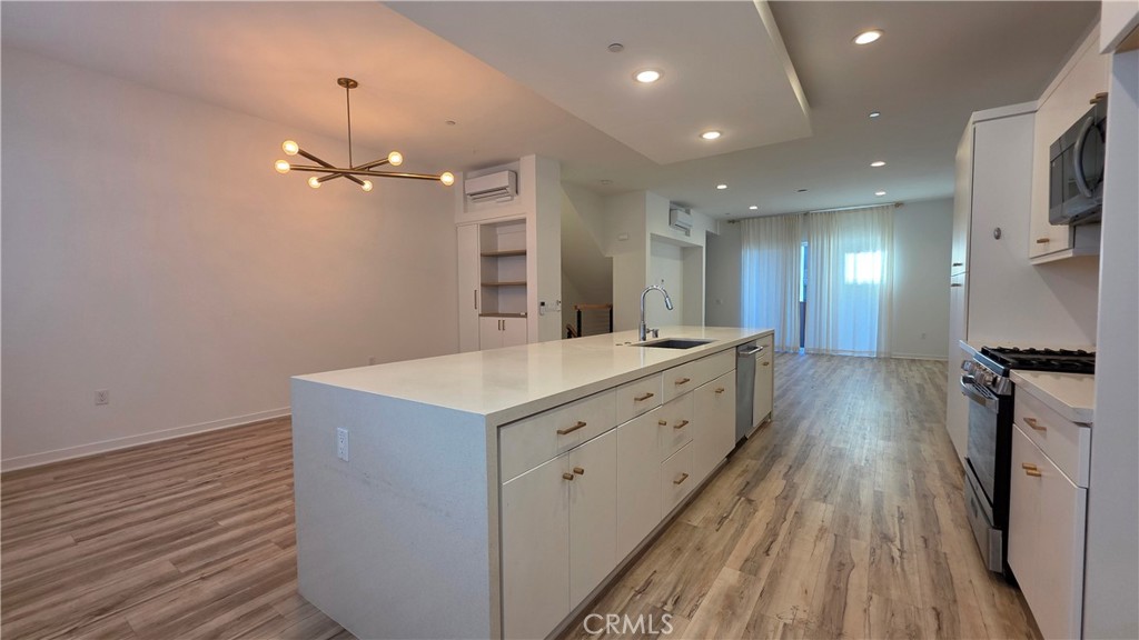 436 Village Brea Ca Brea, CA 92821 - Photo 8 of 26 a large kitchen with a sink and wooden floor