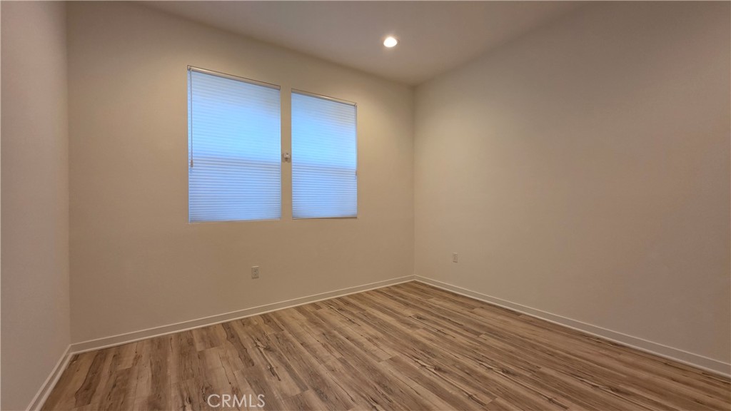 436 Village Brea Ca Brea, CA 92821 - Photo 10 of 30 an empty room with wooden floor and windows